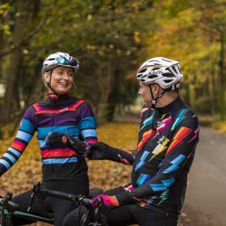 male and female cyclist laughing, wearing Stolen Goat winter kit