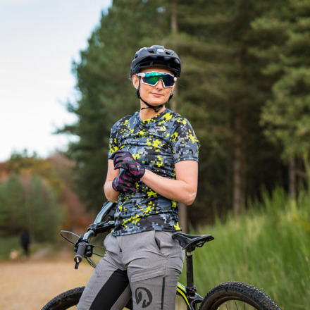 woman wearing stolen goat mountain bike jersey and shorts