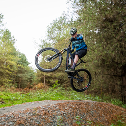 man doing a jump with his mountain bike