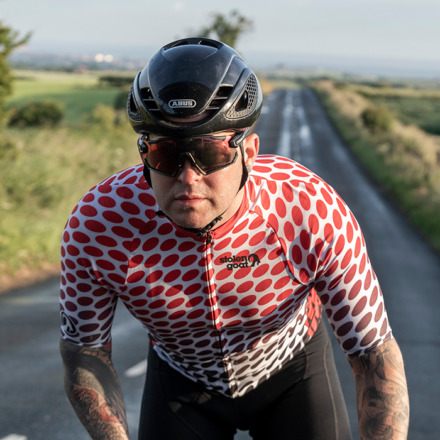 Male rider cycling towards camera wearing Durutti jersey