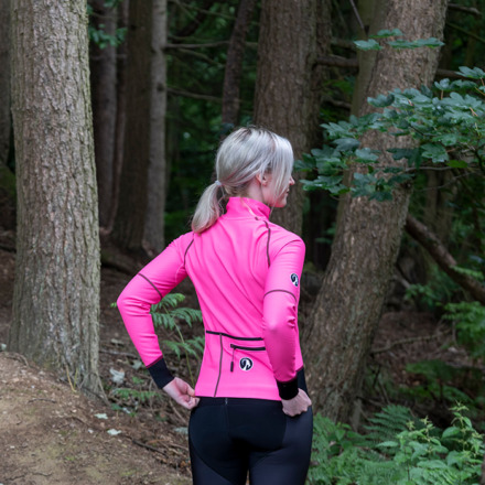 Woman wearing Stolen Goat Alpine Epic pink jacket facing away from camera