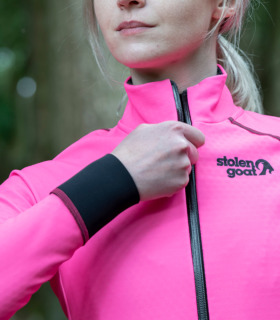 Close up of woman zipping up the Alpine epic jacket