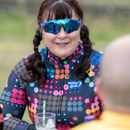 Woman at a cafe wearing Kubrick jersey smiling
