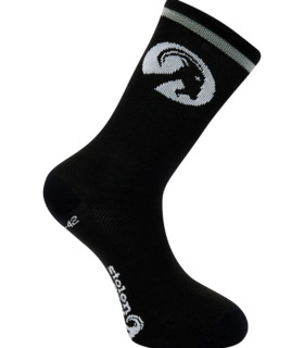 Stolen Goat black merino wool socks, featuring white stolen goat logo and slogan on the sole and round white goat head logo on the ankle with a white band around the top.