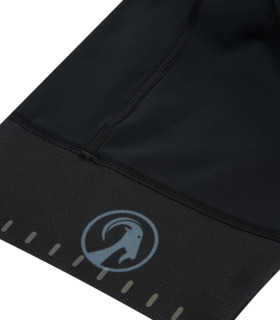 Close up of leg cuff on the women's Black ibex bodyline bib shorts, with grey Stolen Goat goat head logo and small reflective details