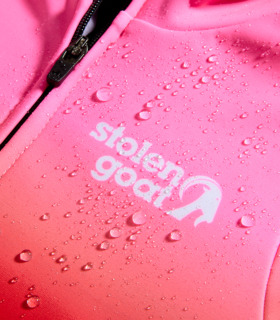 Close up of Stolen Goat logo with water droplets demonstrating water resistance of the jersey
