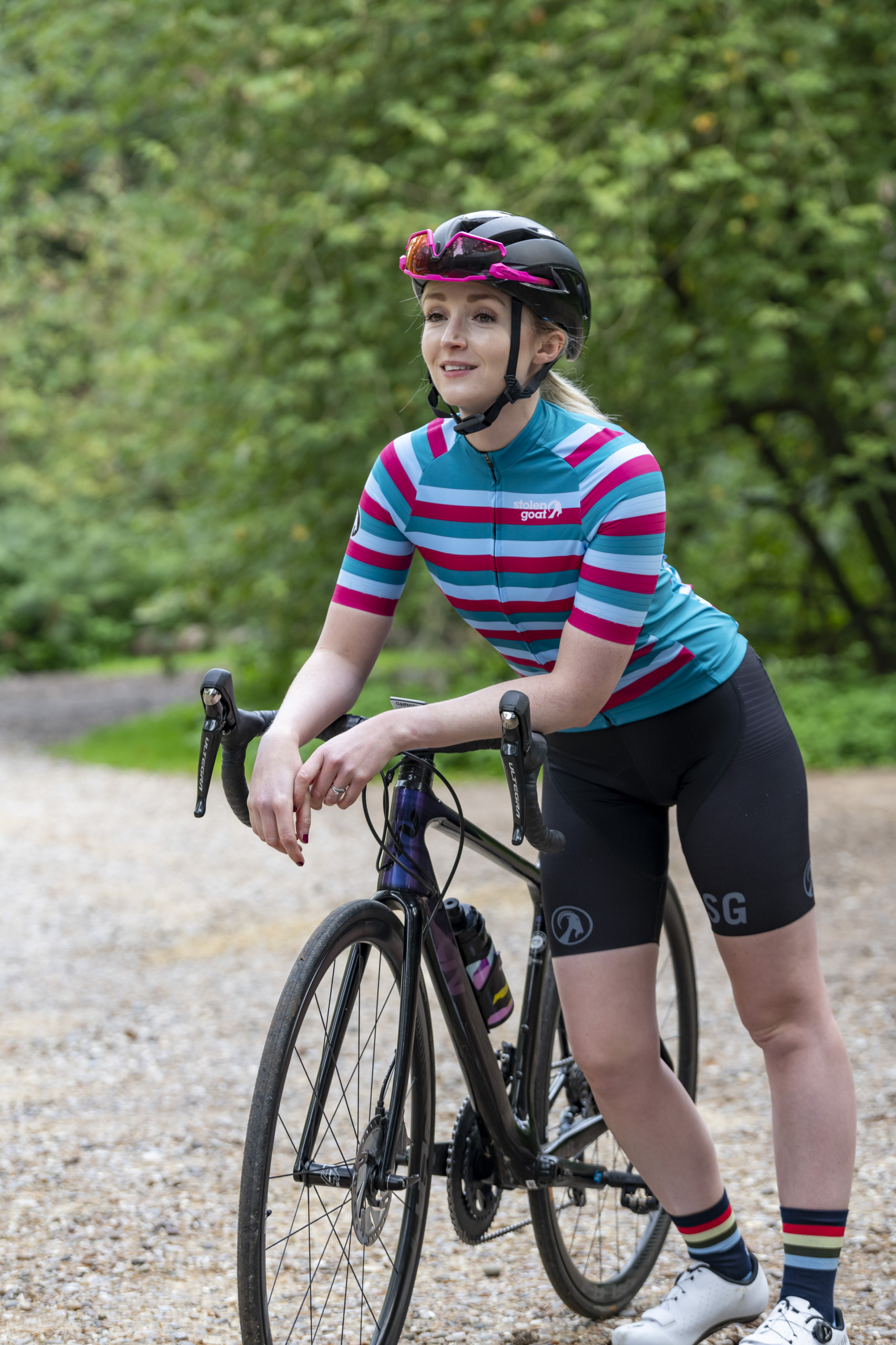 Woman leaning on bike wearing Roxy jersey
