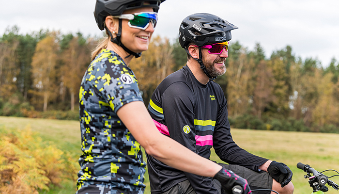 lifestyle image of man and woman in mtb kit
