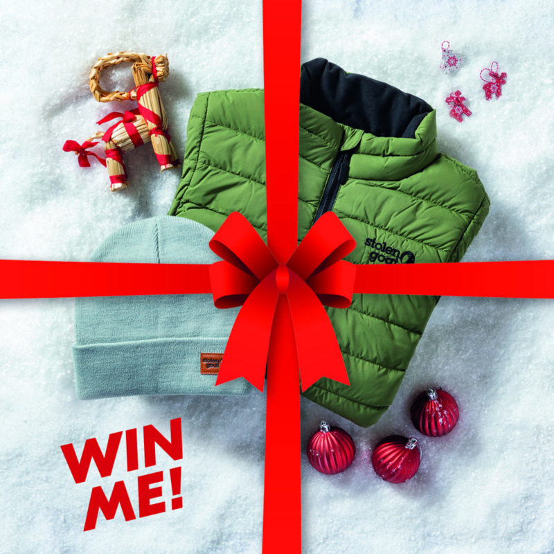 Christmas competition image down jacket and beanie hat on a snowy backdrop with a red ribbon and bow over the top and 'win me' in red text