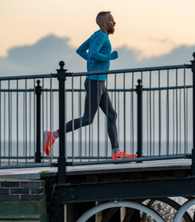 Man wearing the blue long sleeved running top