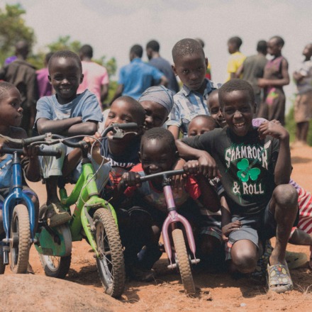 Children posing for a photograph with their bikes at Kasanje Bike Park