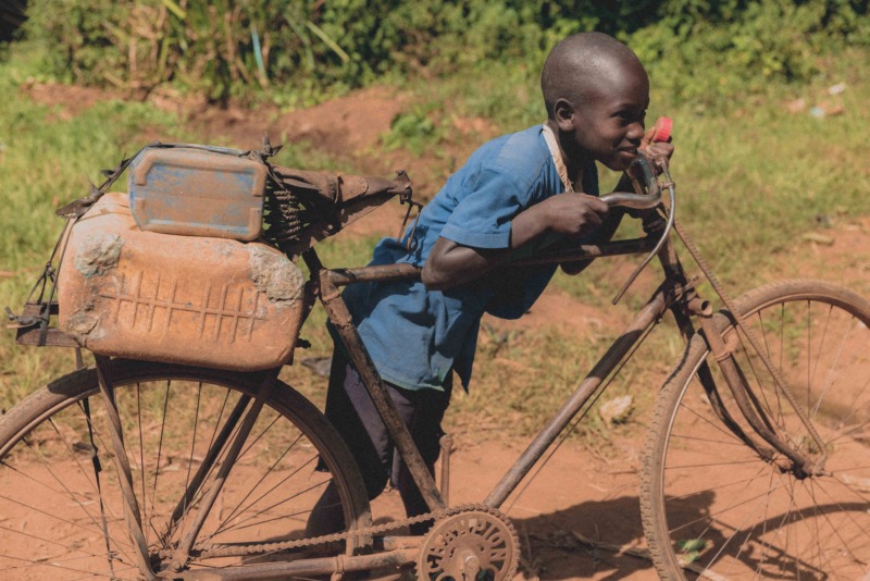 Child with bike at Kasanje Bike track