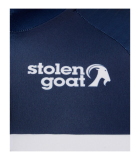Close up of front logo on stolen goat men's Vulcan short-sleeved cycling jersey - navy with white breton stripes and red side panels