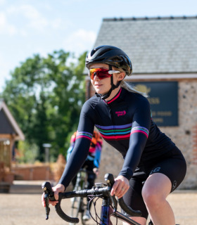 woman cycling wearing blast ibex bodyline jersey