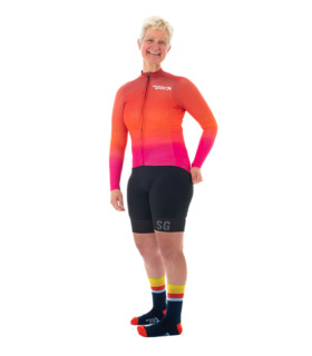 Woman wearing Finn long sleeved cycling jersey facing camera and smiling
