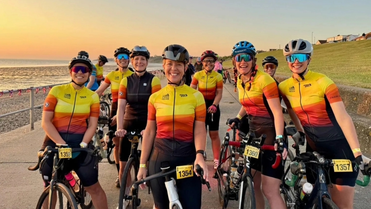 Riders in Chase the Sun event jerseys by Stolen Goat lined up at sunrise before the start